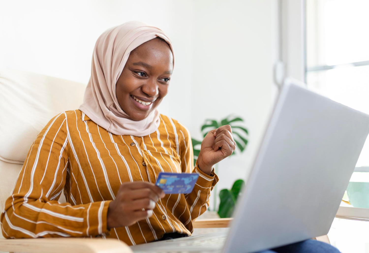 elegant-attractive-muslim-woman-using-mobile-laptop-searching-online-shopping-information-living-room-home-portrait-happy-woman-purchasing-product-via-online-shopping-pay-using-credit-card
